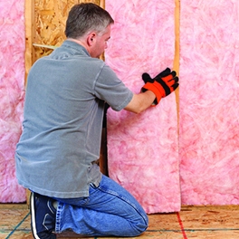 Man installing insulation 